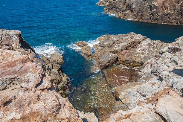 istock Huge sedimentary rocks by the ocean 492807386