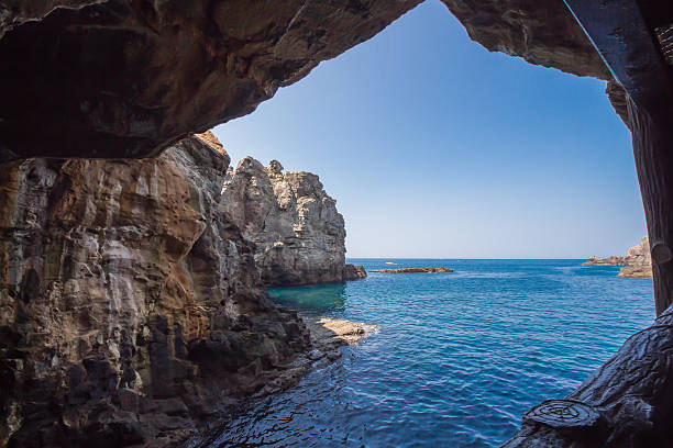 istock Huge sedimentary rocks by the ocean 492807588