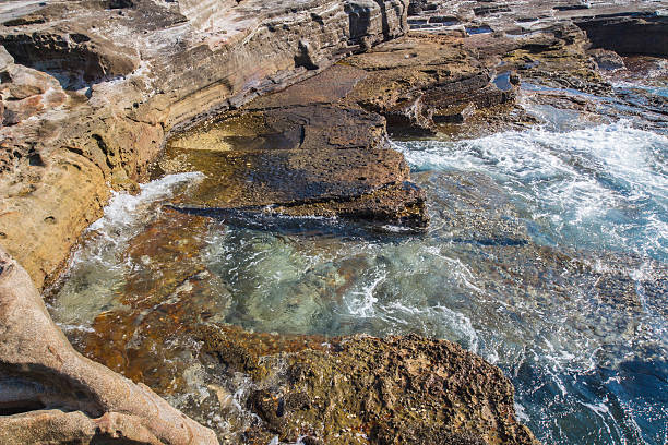 istock Huge sedimentary rocks by the ocean 492807784