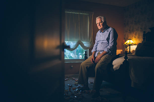 Medicine addiction Depressed senior man alone sitting on bed edge with dozens of pill container at his feet old man depressed stock pictures, royalty-free photos & images