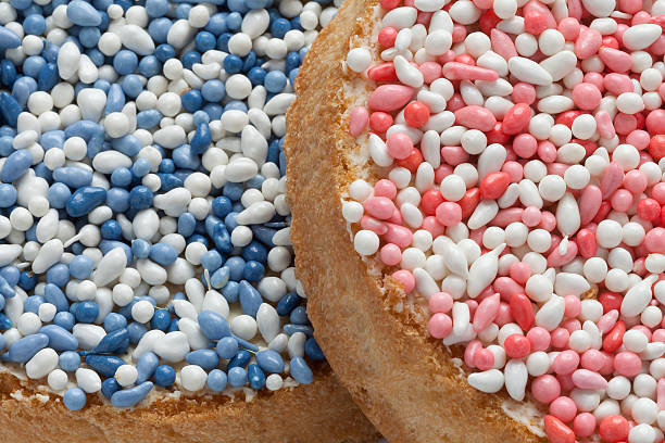 Beschuit met muisjes, a traditional dutch treat 'Beschuit met muisjes, a traditional treat to celebrate the birth of a child in The Netherlands. Pink sprinkles for a girl, blue for a boy zwieback toast stock pictures, royalty-free photos & images