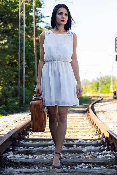 fuß auf gleise - leaving loneliness women railroad track stock-fotos und bilder