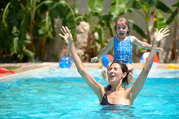 istock Mother and daughter in swimming pool 492811714