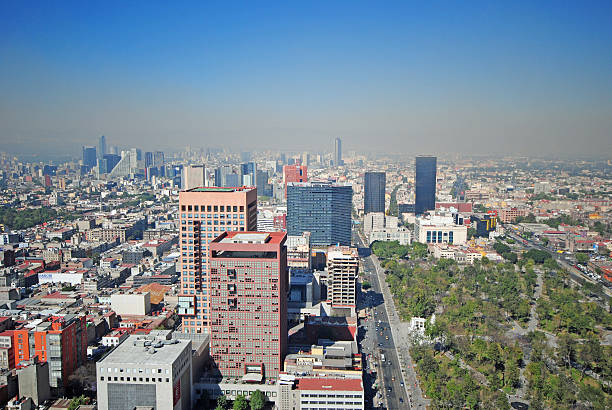 Cityscape in the south of Mexico City, view towards east, with office and apartment buildings in the background and residential neighborhood in the foreground