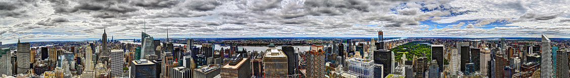 HDR 360 degree panorama of the Manhattan skyline on a cloudy afternoon.