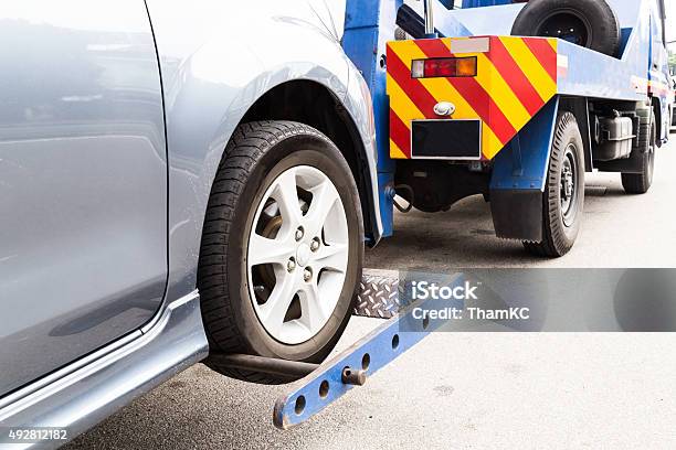 Tow Truck Towing A Broken Down Car On The Street Stock Photo - Download Image Now - Towing, Tow Truck, Car