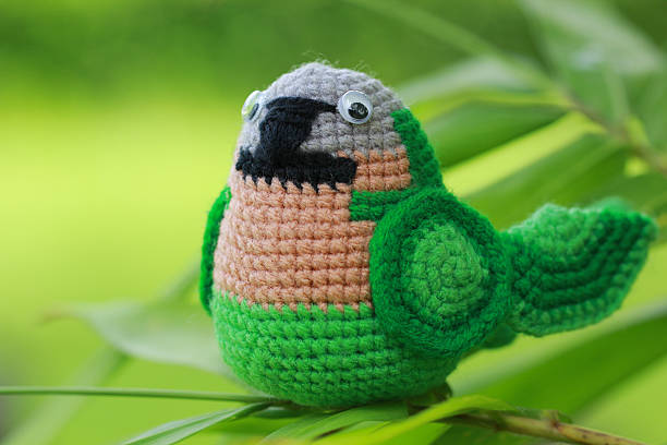 istock handmade crochet doll parrot on green background 492813560