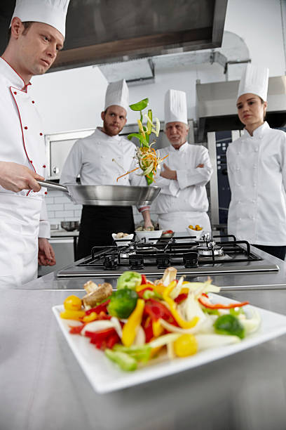 istock Young chef cooking vegetable in pan. 492813834