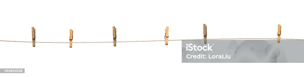 Old wooden clothespins on a rope isolated Old wooden clothespins on a rope isolated on  white background Clothesline Stock Photo
