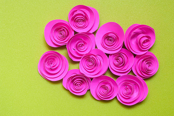 istock pink paper rose isolated on green background 492815105
