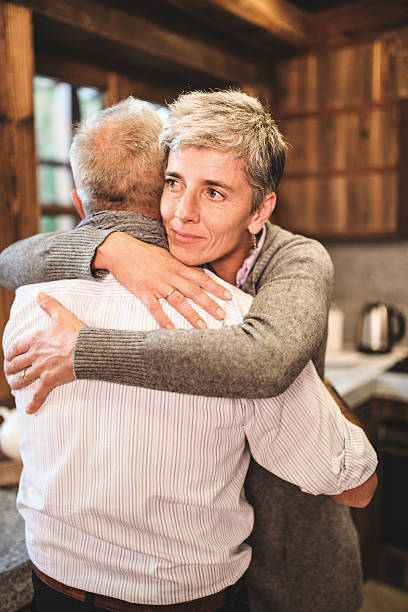 istock senior couple embracing passionate in the house - support concept 492815508