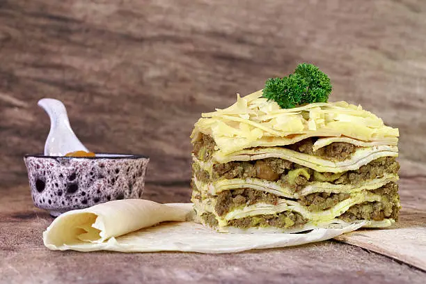 Photo of South African bobotie dish layered with pancakes