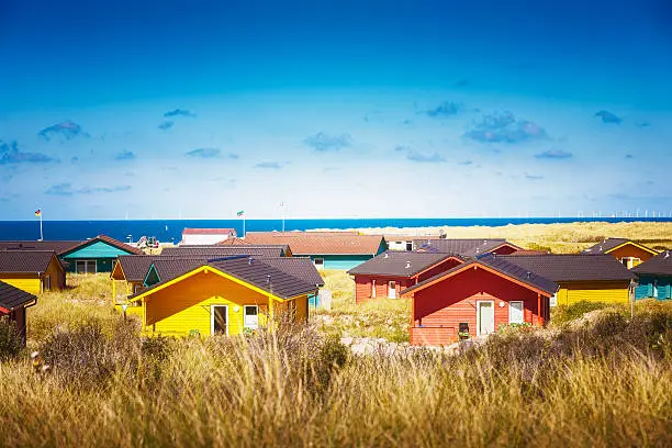 Colorful beach houses in dune grass at the beach of Helgoland, North sea, Germany. Travel destinations. Selective focus