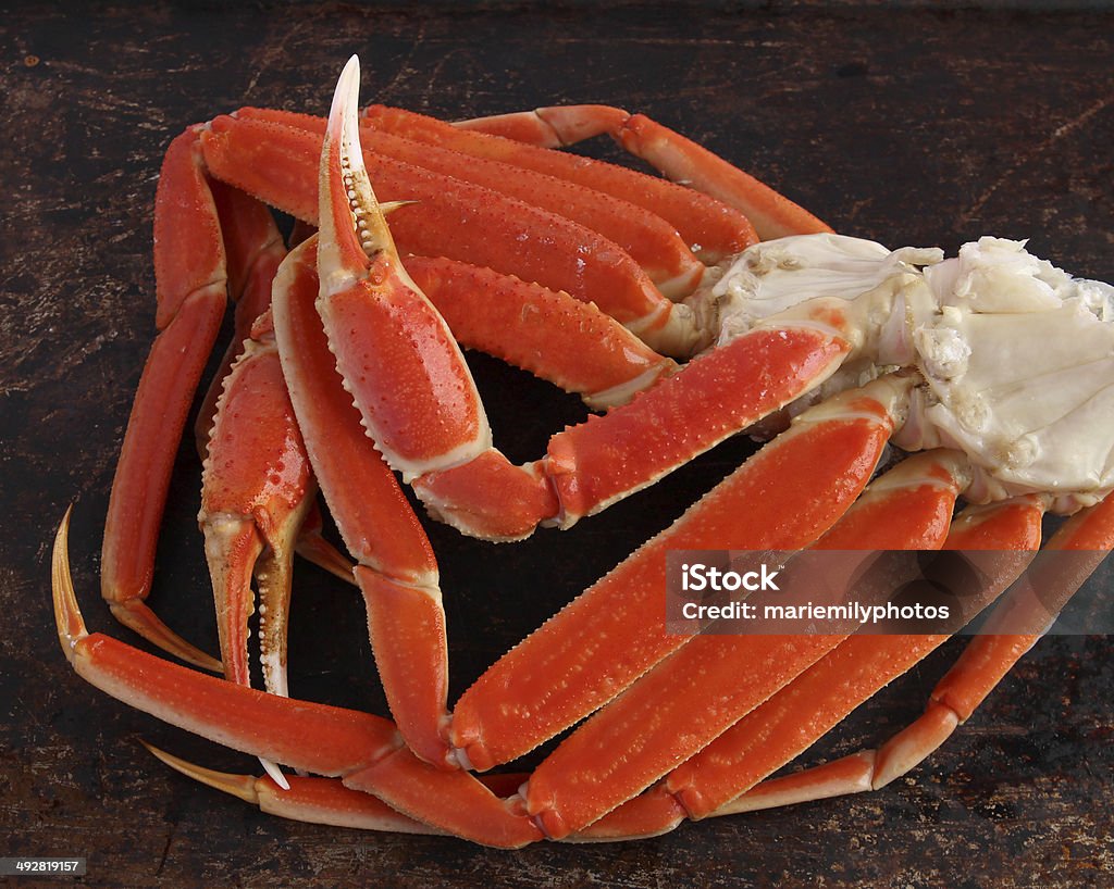 Crab legs Crab legs on brown background Bunch Stock Photo