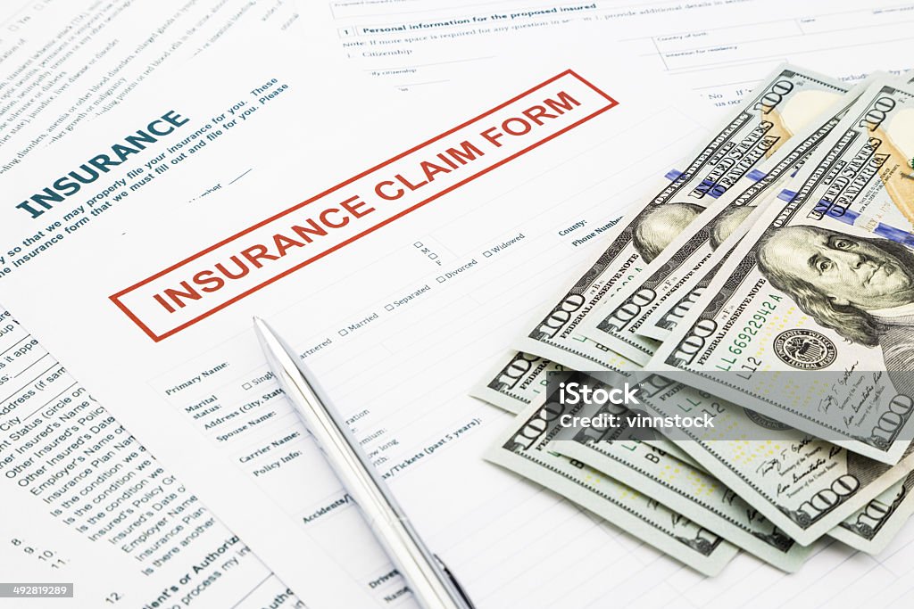 Insurance claim form and money Insurance claim form and compensate money, accidental and insurance concepts Insurance Stock Photo