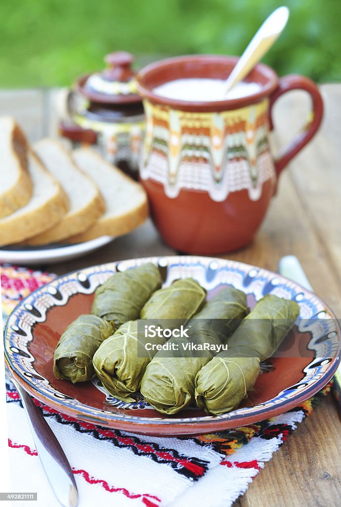 Dolmades Dolmades - stuffed grape leaves and natural yogurt Appetizer Stock Photo