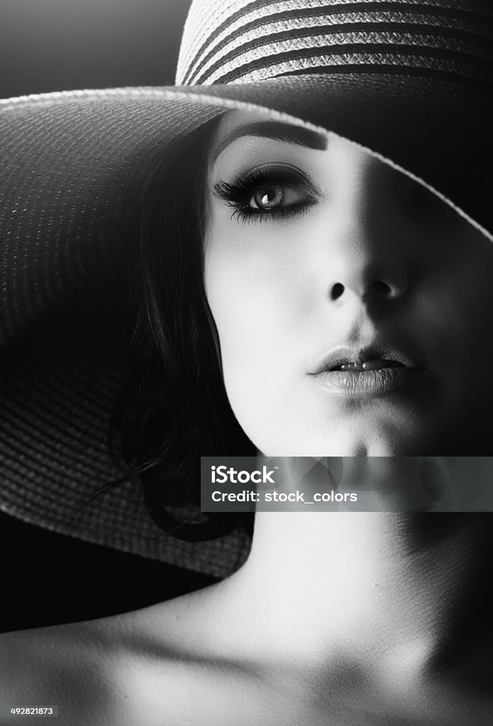 elegance black and white pgoto with retro woman wearing hat and looking away. Women Stock Photo