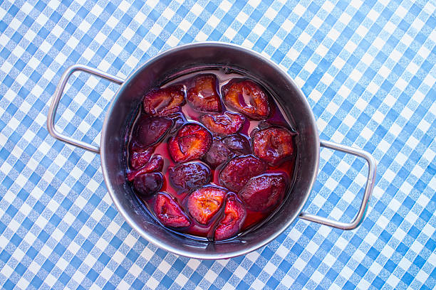 Plum jam Pan with plum jam or compot from above compote photos stock pictures, royalty-free photos & images