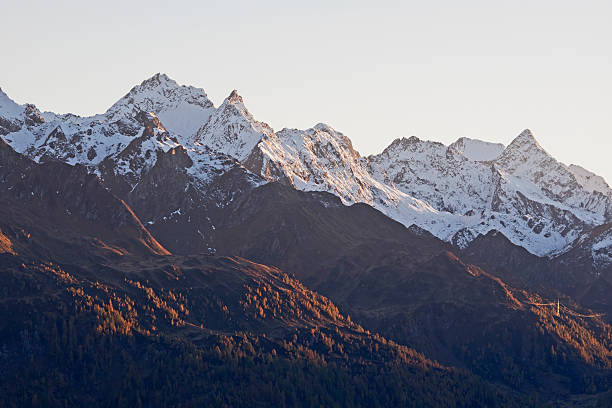 Snow covered mountain peaks in the evening light Outdoor telephoto photography of snow covered mountain peaks in the evening sunlight. gotthard pass stock pictures, royalty-free photos & images