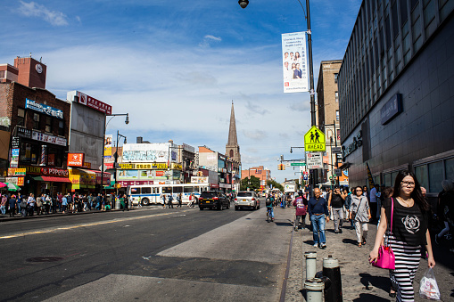 Flushing, NY, USA - September 21, 2015: People walking along Main Street in Flushing Queens' Chinatown.