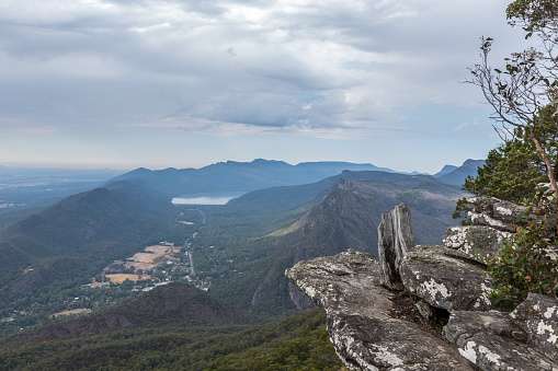 DSLR picture of the Grampians National Park in Halls Gap, Australia. The picture was taken from the hiking trail. The footpath is on the summit of the mountain where there is a beautiful view of the mountains from the observation point. 
