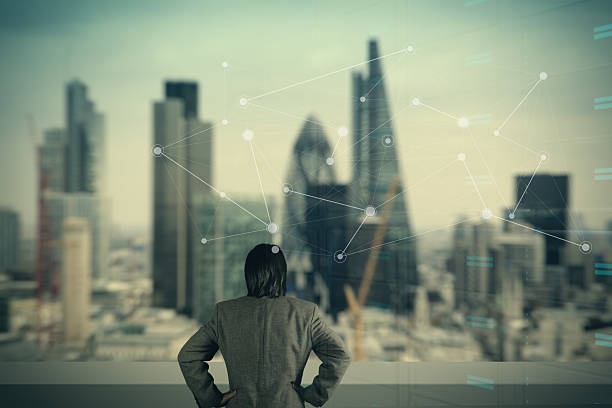 istock businessman stands successfully on building top Looking Towards 492846176