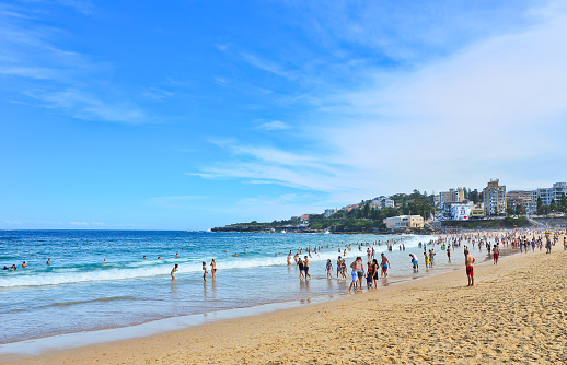 Coogee Beach, Sydney, Australia - January 24, 2015: Tourists and swimmers having fun on the beach in summer at Coogee Beach on January 24, 2015.