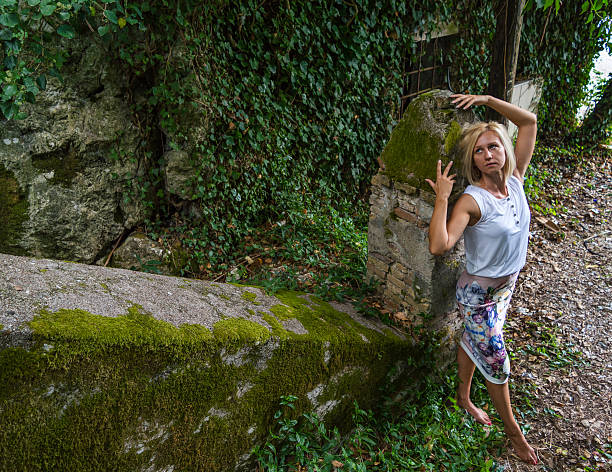 istock Interesting mysterious blonde posing in green autumn forest 492851288