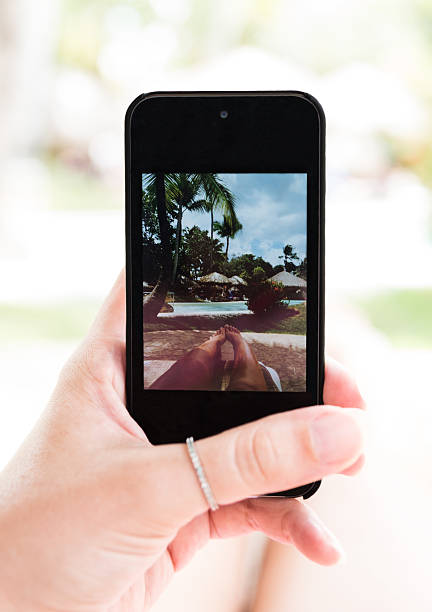 istock Woman's hand with cellphone taking selfie of her legs 492852312