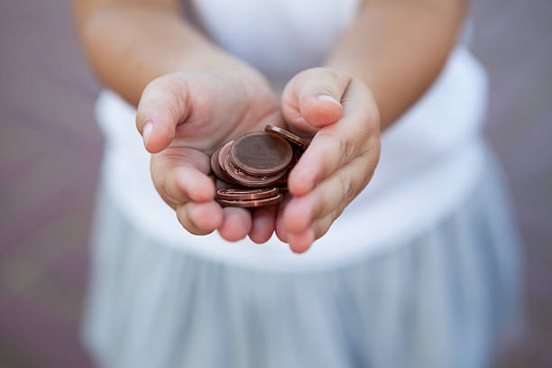 istock Little Girl Holding Coins 492853138