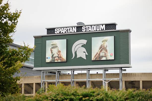 Spartan Stadium East Lansing, Michigan, USA - August 8, 2015: Photograph of sign on back of scoreboard at Spartan Stadium on the campus of Michigan State University in Lansing, Michigan.    Image taken near the intersection of Red Cedar Road and West Shaw Lane. michigan football stock pictures, royalty-free photos & images