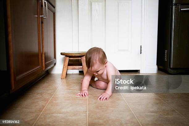Baby Is Grasping Tiny Crumbs In Kitchen Stock Photo - Download Image Now - Baby - Human Age, Danger, Reaching