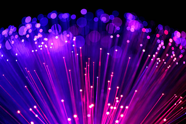Fiber optics abstract background (blue-purple) Fiber optics abstract purple background. Defocused lights and lines create the motion blur effect. fiber optic photos stock pictures, royalty-free photos & images
