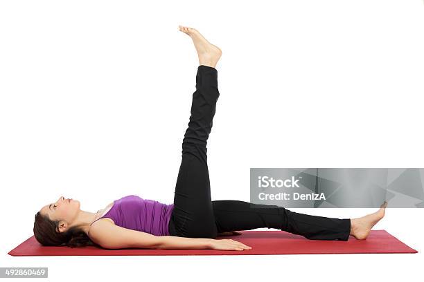 Woman Doing Leg Raising Exercises Stock Photo - Download Image Now - 30-34 Years, Abdominal Muscle, Active Lifestyle