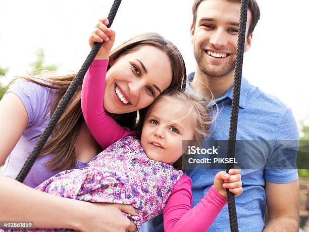 Family On A Swing Stock Photo - Download Image Now - Enjoyment, Family, Playground