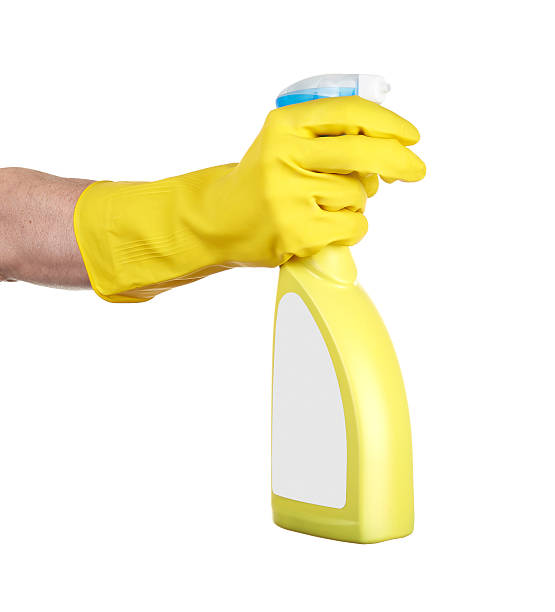 istock Hand with rubber glove holding a cleaning spray 492862083