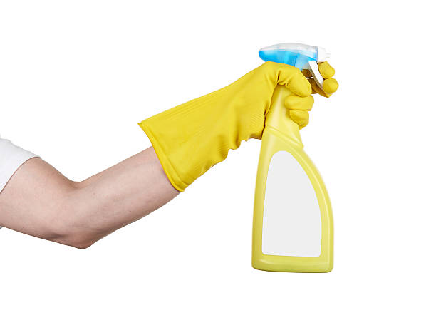istock Hand with rubber glove holding cleaning spray 492862085