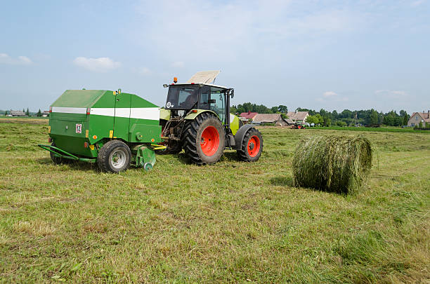 istock tractor bailer collect hay in agriculture field 492863343