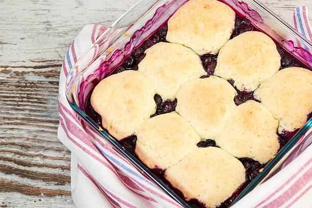 cobbler Blueberry cobbler on a wooden table marionberry stock pictures, royalty-free photos & images