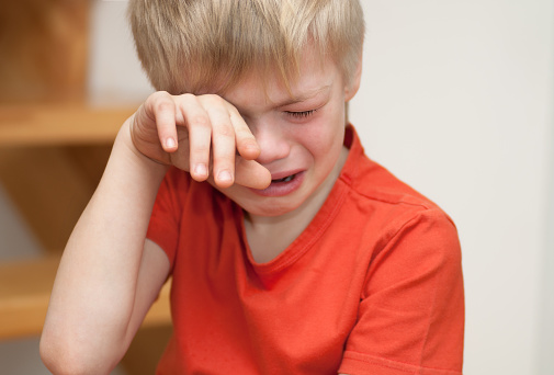 Boy cries of resentment and grief