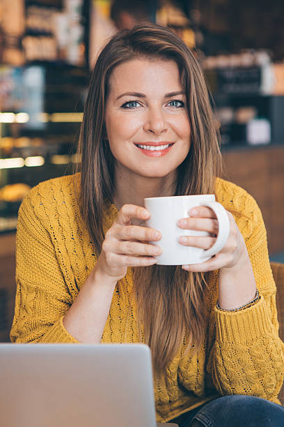 istock Woman with laptop at cafe. 492881036