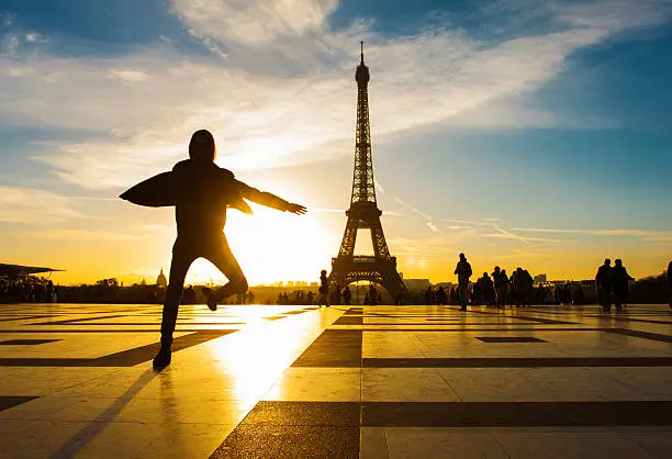 Young attractive woman in Paris. Amazing sunrise on trocadero place and eiffel tower in Paris