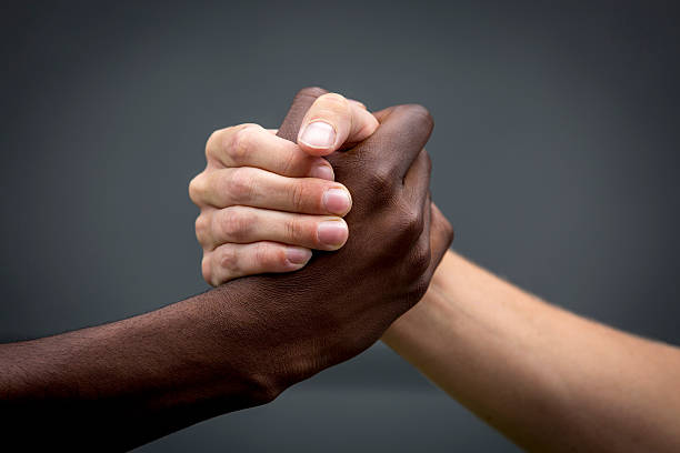 hands,black and white handshake, hands,black and white,refugees are welcome, racism photos stock pictures, royalty-free photos & images