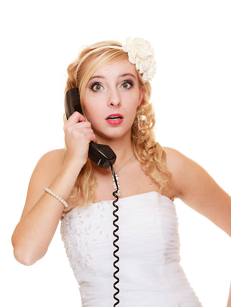 istock Wedding. Surprised woman bride talking on phone 492884328