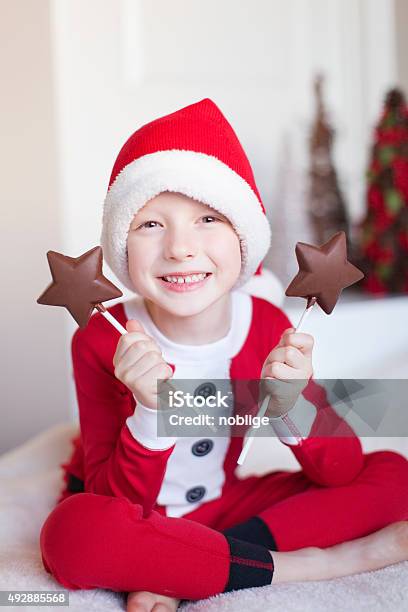 Boy At Christmas Time Stock Photo - Download Image Now - 2015, Bed - Furniture, Boys