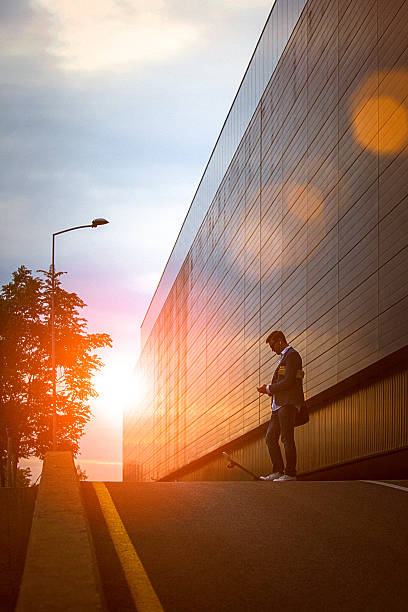 istock Young entrepreneur using smartphone in the urban environment at sunset 492889274
