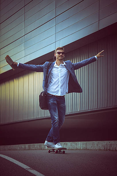 istock Young happy entrepreneur riding a skateboard with wide open arms 492889318