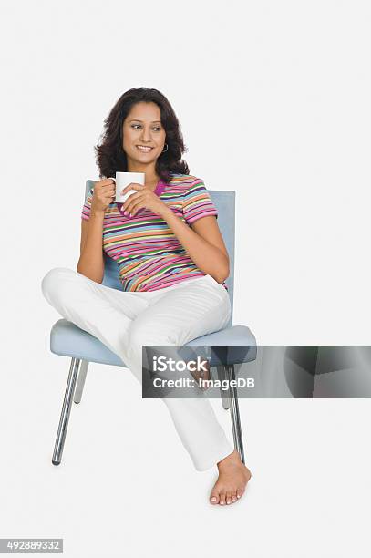 Woman Sitting On A Chair And Drinking Tea Stock Photo - Download Image Now - Drinking, Tea - Hot Drink, White Background