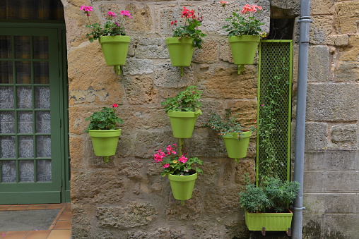 An array of green flower pots seen in the medieval part of Montignac