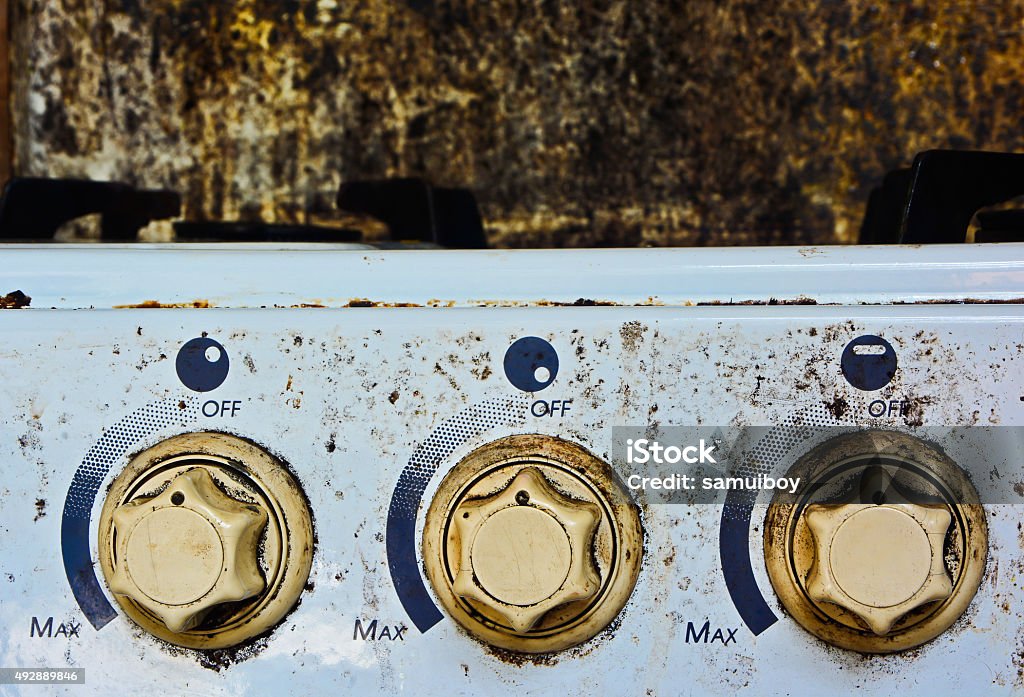 Gas Range Control Buttons of the gas stove Gas Range Control Buttons of the gas stove stained wall background 2015 Stock Photo